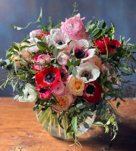 Hand tied bouquet in a glass bubble vase